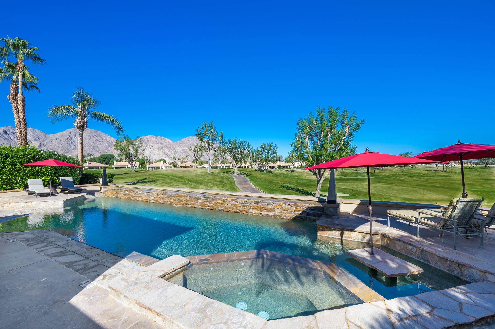 80128 Riviera La Quinta, CA 92253 - Photo 31 of 33 a view of a patio with a table and chairs under an umbrella