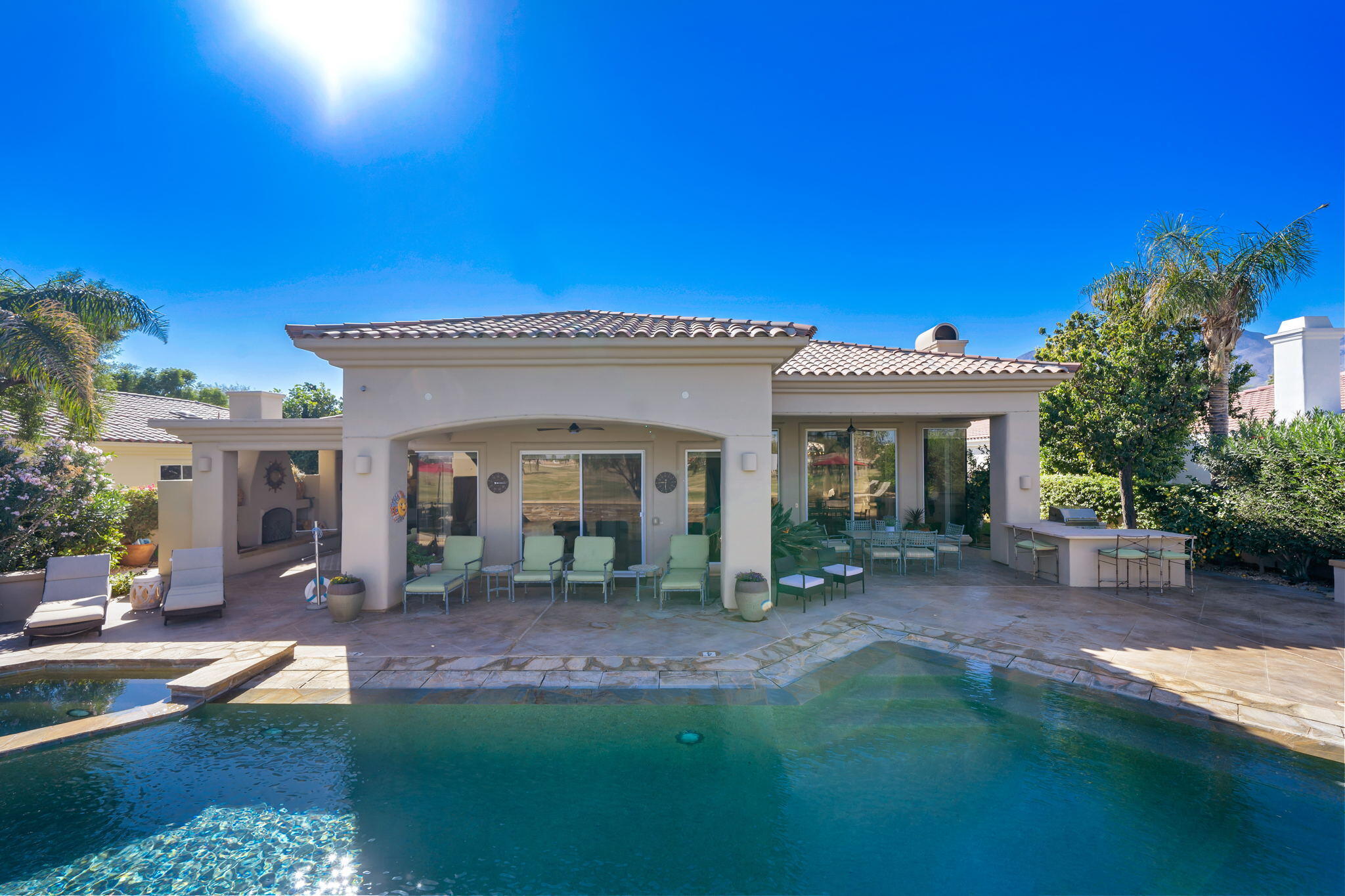 80128 Riviera La Quinta, CA 92253 - Photo 32 of 33 a view of a house with backyard porch and sitting area