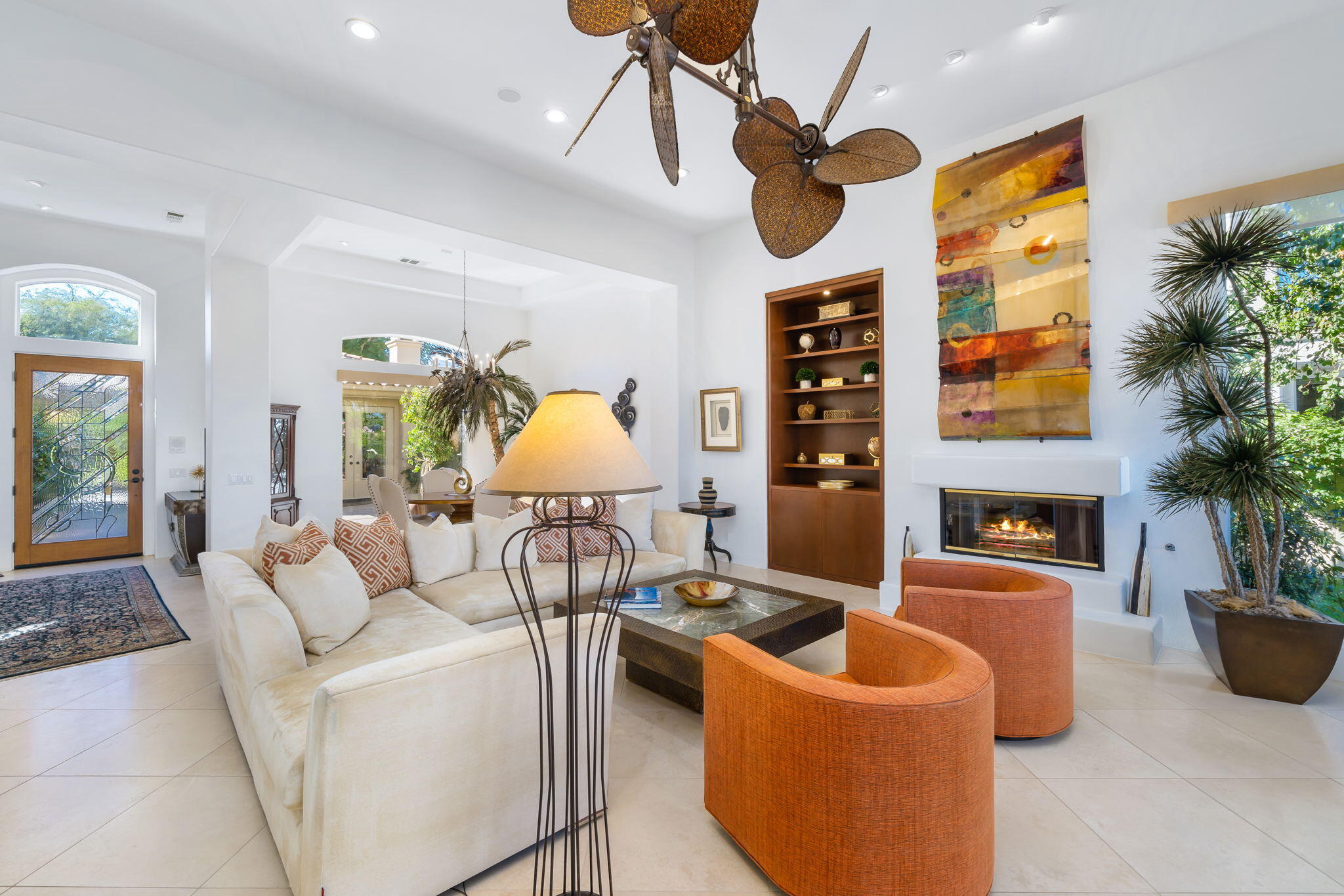 80128 Riviera La Quinta, CA 92253 - Photo 9 of 33 a living room with furniture a chandelier and a fireplace