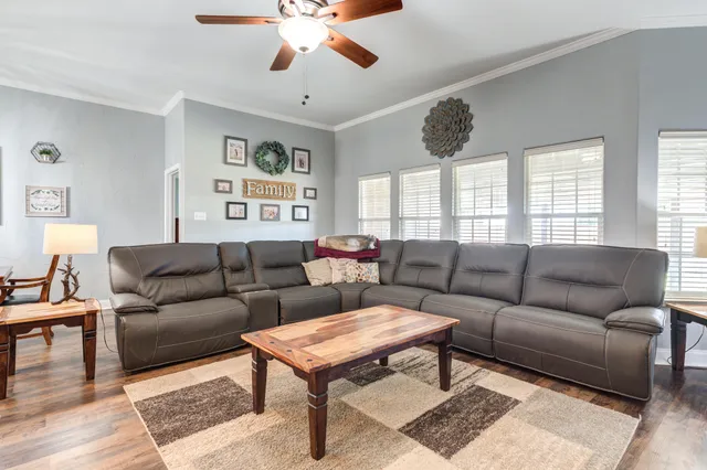 a living room with furniture a chandelier and a window