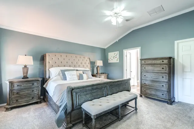 a bedroom with a bed and a chandelier