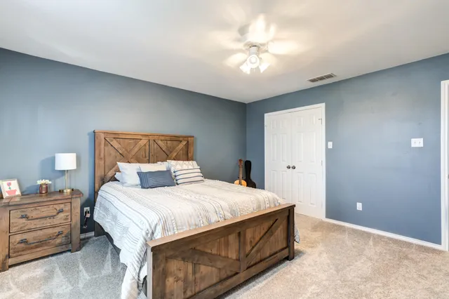 a bedroom with a bed and a chandelier