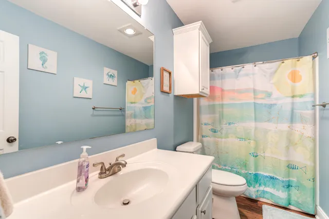 a bathroom with a sink toilet and shower