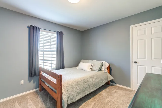 a bedroom with a bed and window