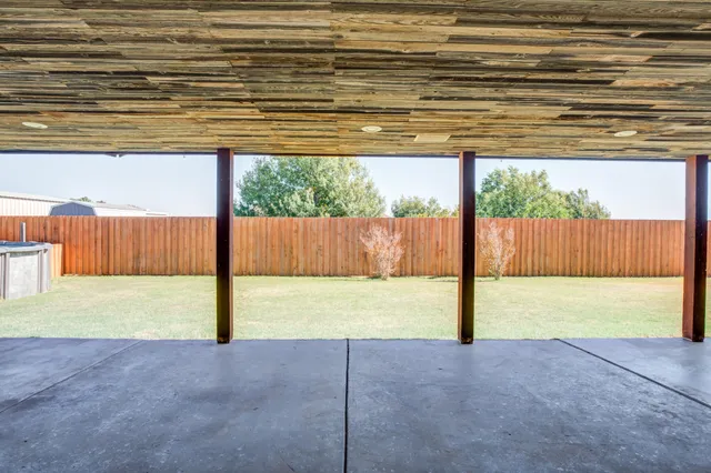 a view of back yard of the building with a yard