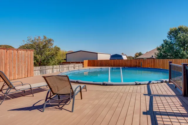 a balcony with a table and chairs