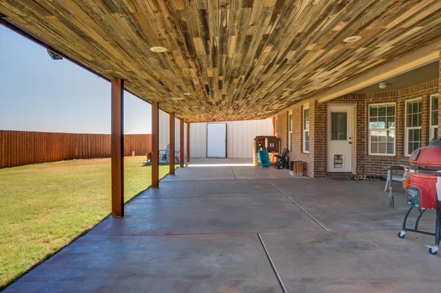 a view of a porch with furniture and floor to ceiling window