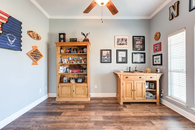 a hall with a cabinet and a rug
