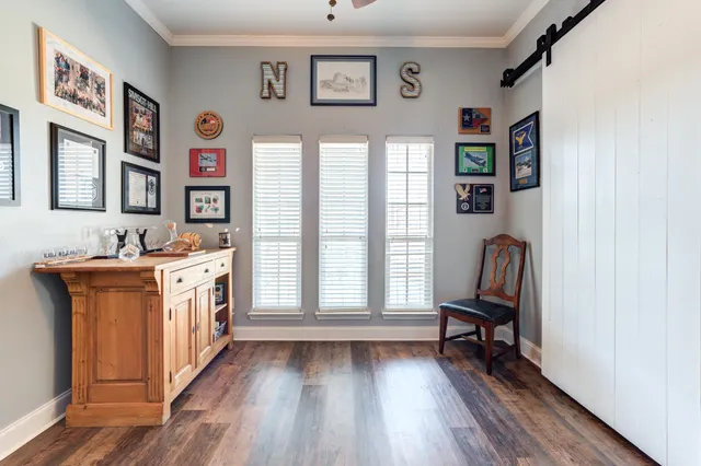 a view of a livingroom with workspace and a window