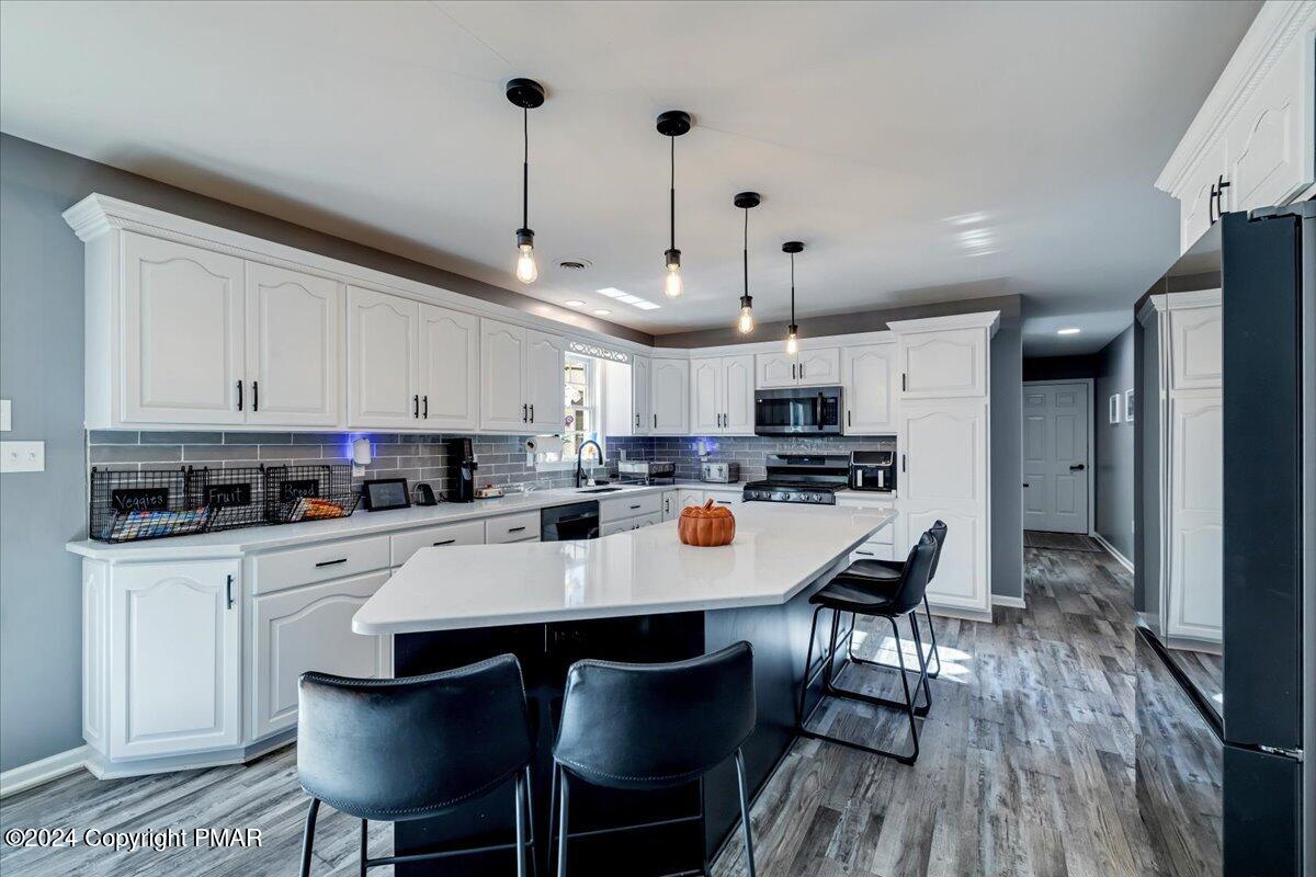 439 5 Points Richmond Road Bangor, PA 18013 - Photo 12 of 50 a kitchen with stainless steel appliances a white table and chairs in it
