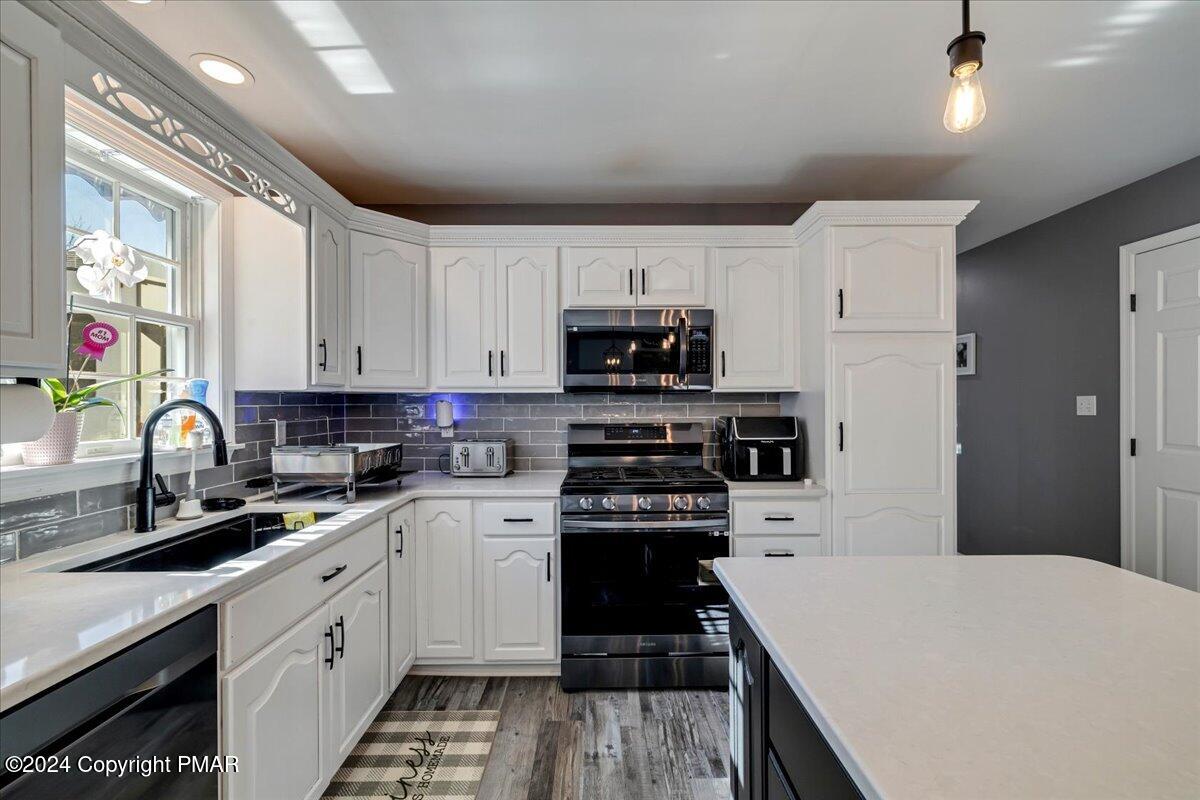 439 5 Points Richmond Road Bangor, PA 18013 - Photo 13 of 50 a kitchen with a sink a stove and cabinets