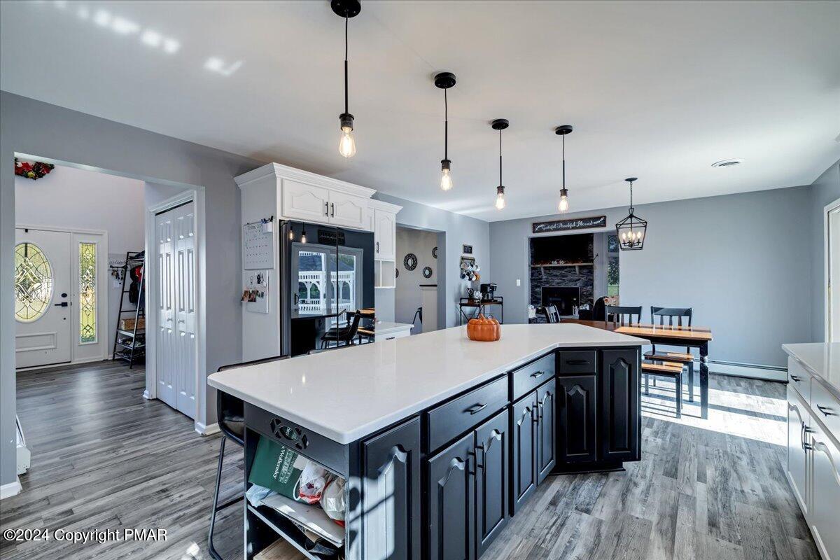 439 5 Points Richmond Road Bangor, PA 18013 - Photo 15 of 50 a large kitchen with kitchen island a island a stove a sink a refrigerator and a dining table with wooden floor