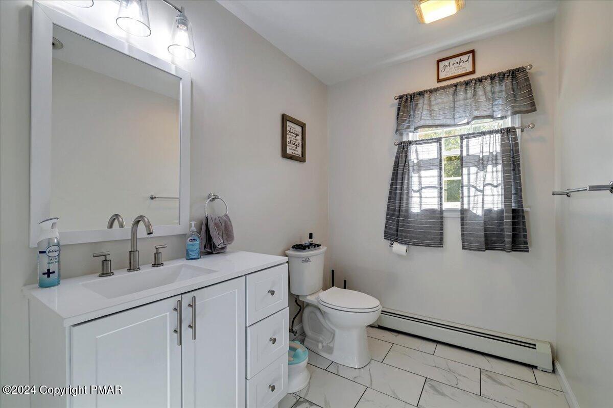 439 5 Points Richmond Road Bangor, PA 18013 - Photo 22 of 50 a bathroom with a toilet sink and mirror