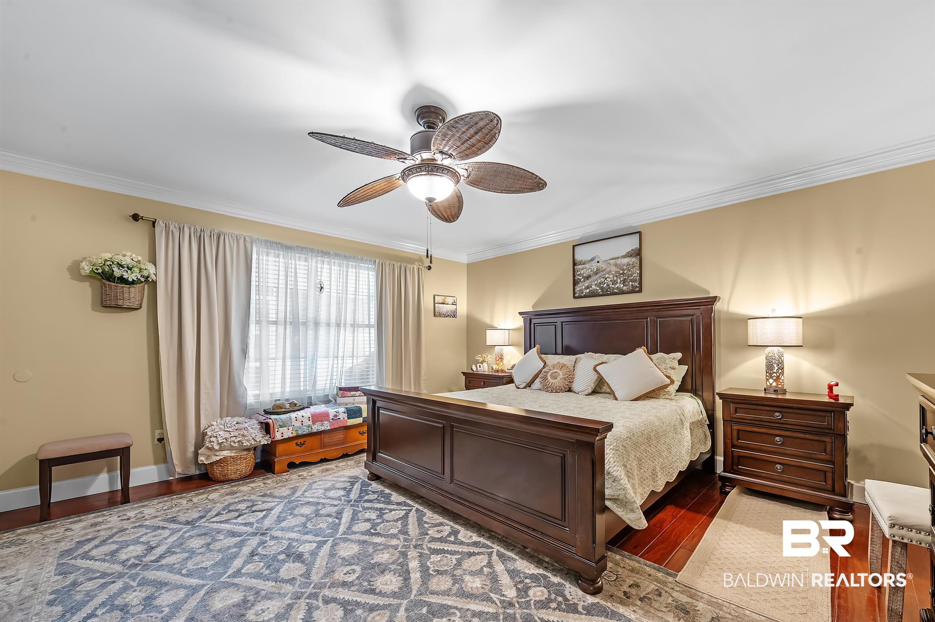 9901 Glover Court Fairhope, AL 36532 - Photo 18 of 52 Bedroom featuring ceiling fan, hardwood / wood-style flooring, and crown molding