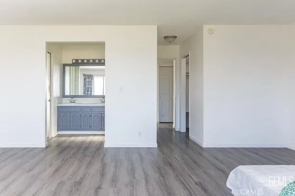 a view of a hallway with wooden floor and closet