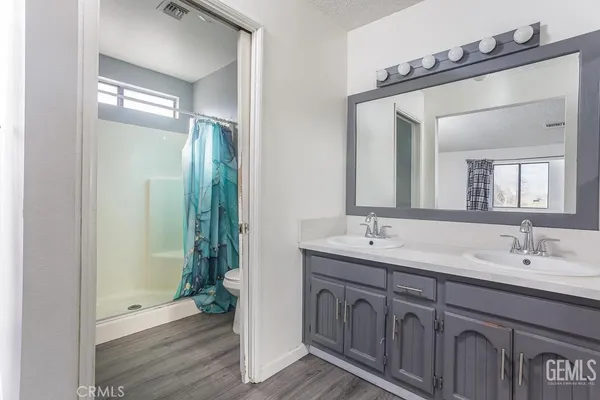 a bathroom with 2 sink and a mirror