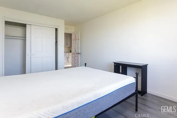 a bedroom with a bed and a mirror