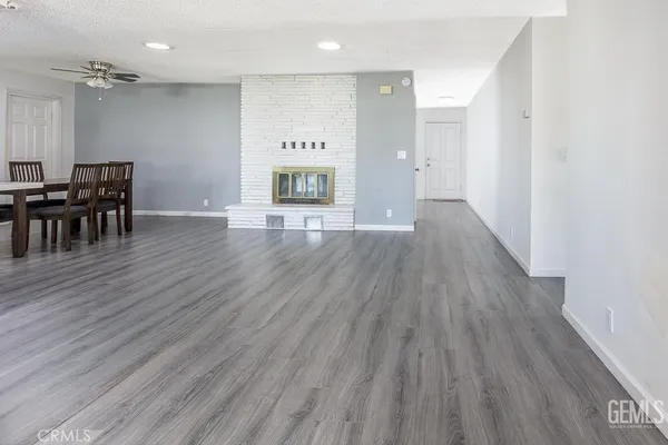 a view of a room with wooden floor
