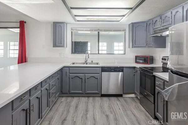 a kitchen with a sink stove and cabinets