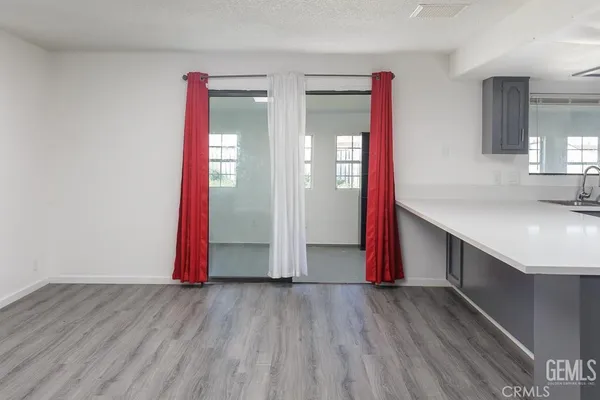 a view of a room with wooden floor and window