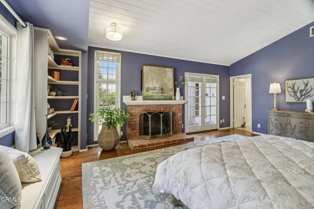 a bedroom with a bed and a fireplace