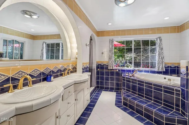 a kitchen with stainless steel appliances a stove refrigerator sink and cabinets