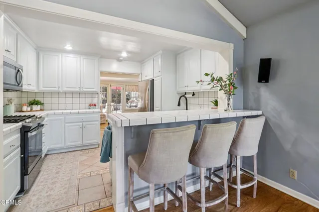 a kitchen with appliances a refrigerator and a sink