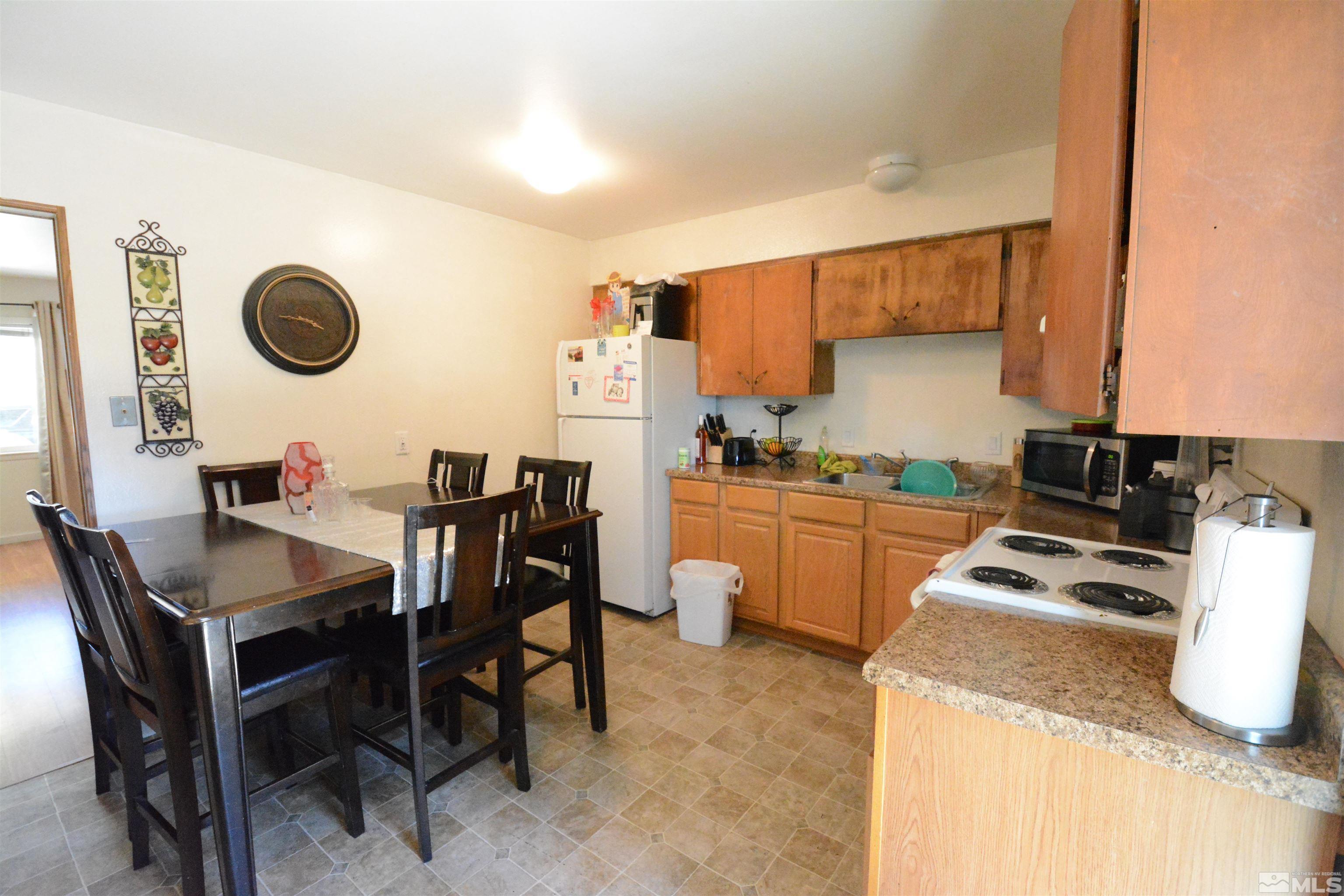 1930 Trainer Way Reno, NV 89512 - Photo 13 of 24 a kitchen with a dining table and chairs