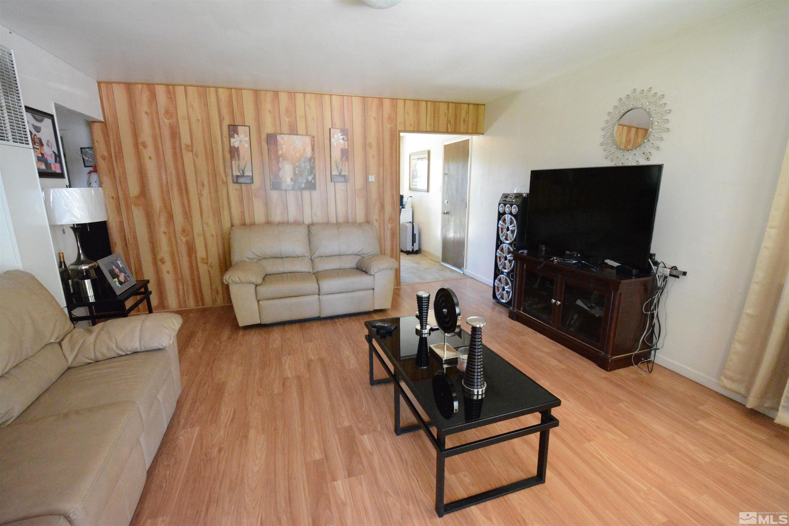 1930 Trainer Way Reno, NV 89512 - Photo 17 of 24 a living room with furniture a flat screen tv and a fireplace
