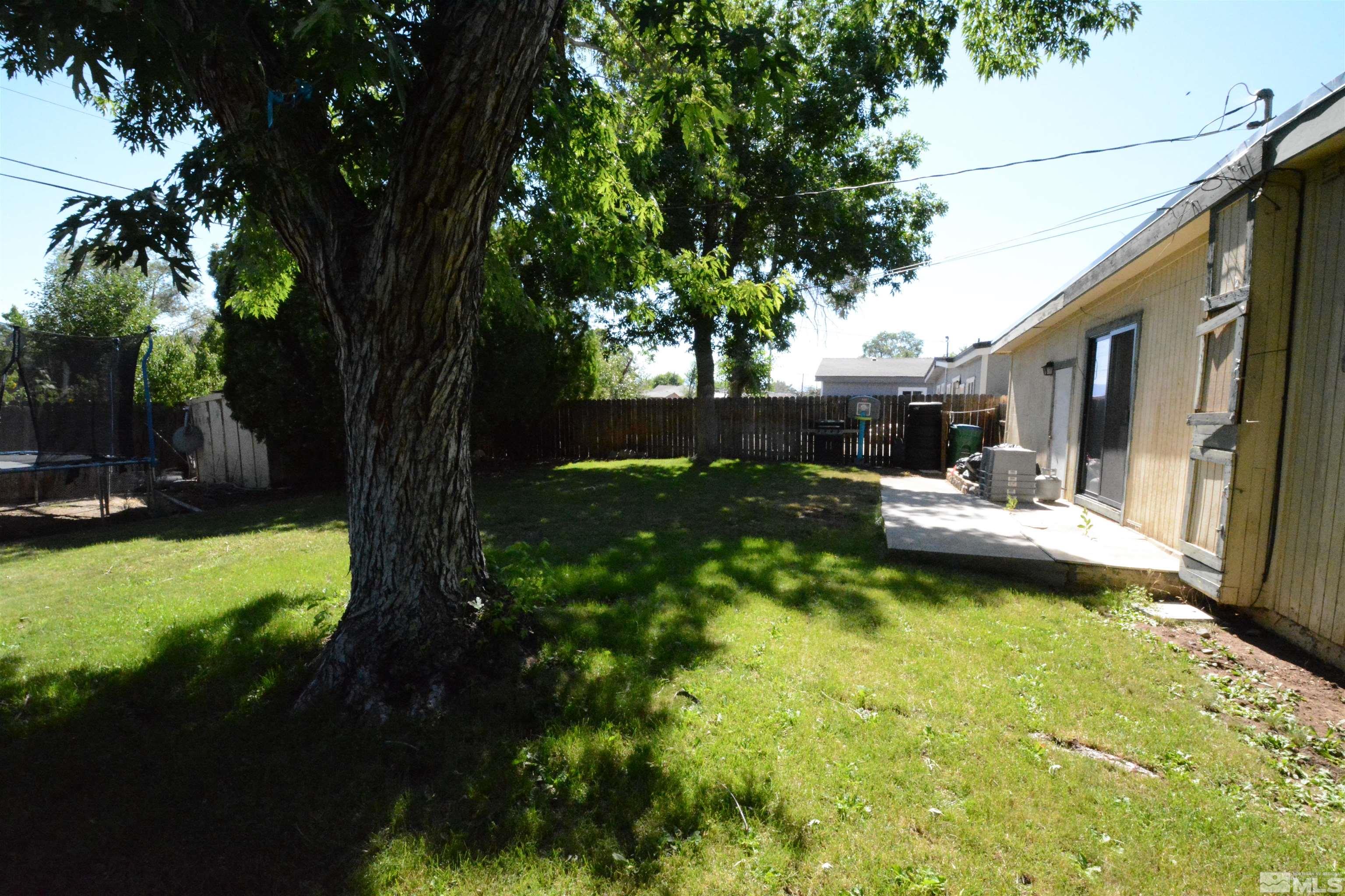 1930 Trainer Way Reno, NV 89512 - Photo 19 of 24 a view of a patio with table and chairs plants and large trees