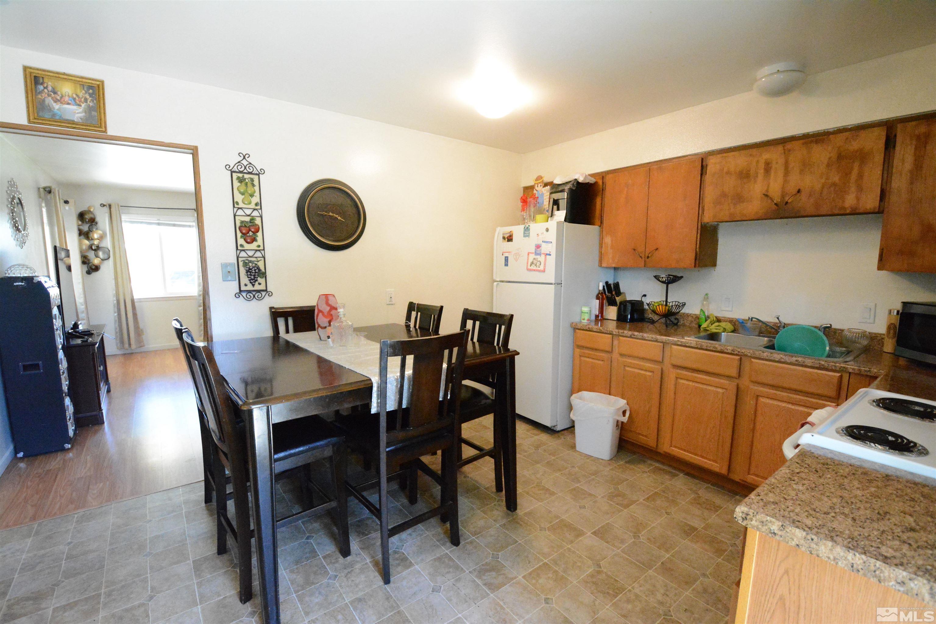 1930 Trainer Way Reno, NV 89512 - Photo 5 of 24 a kitchen with a dining table chairs and white cabinets
