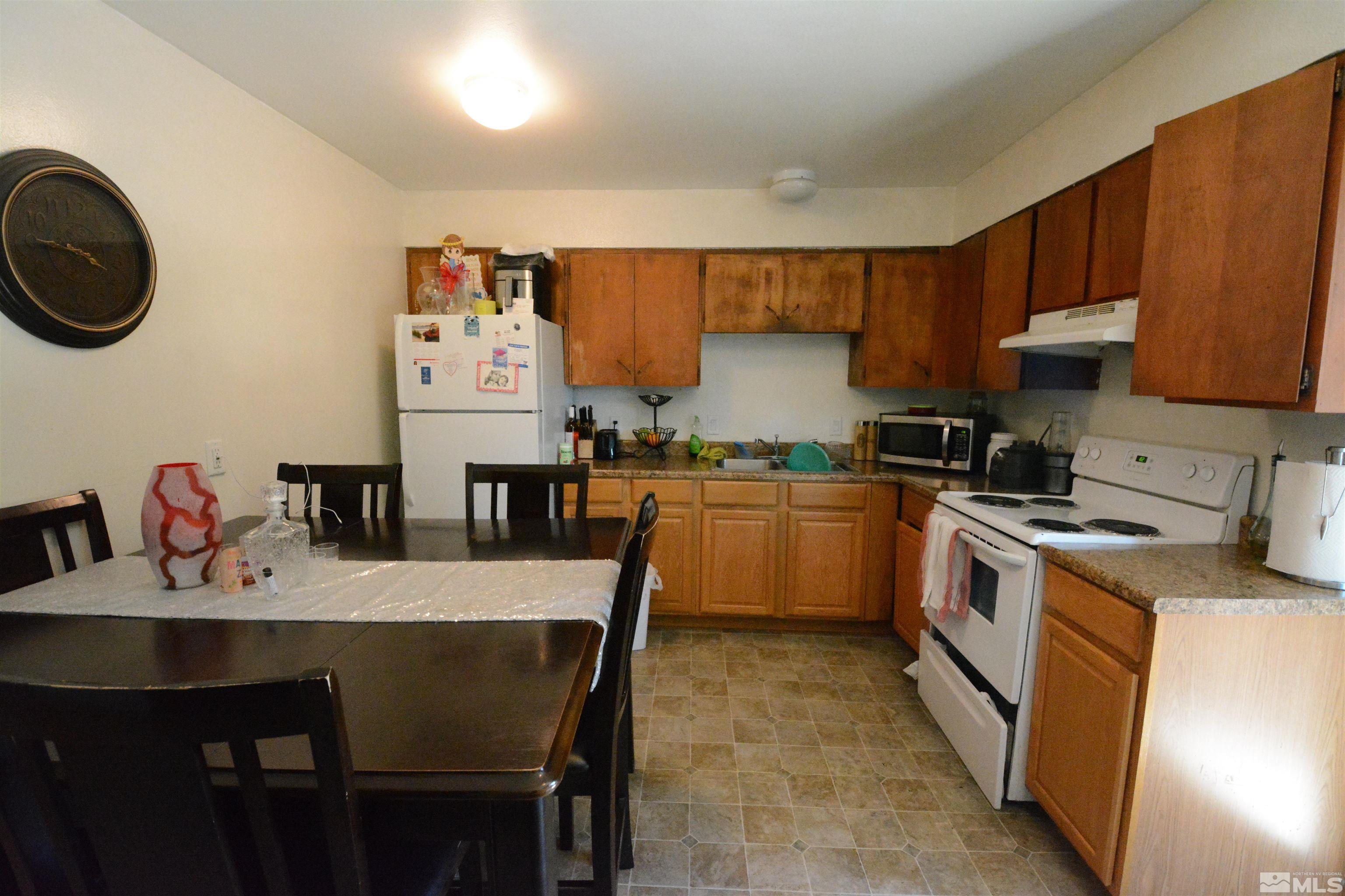 1930 Trainer Way Reno, NV 89512 - Photo 6 of 24 a kitchen with a table chairs stove and cabinets
