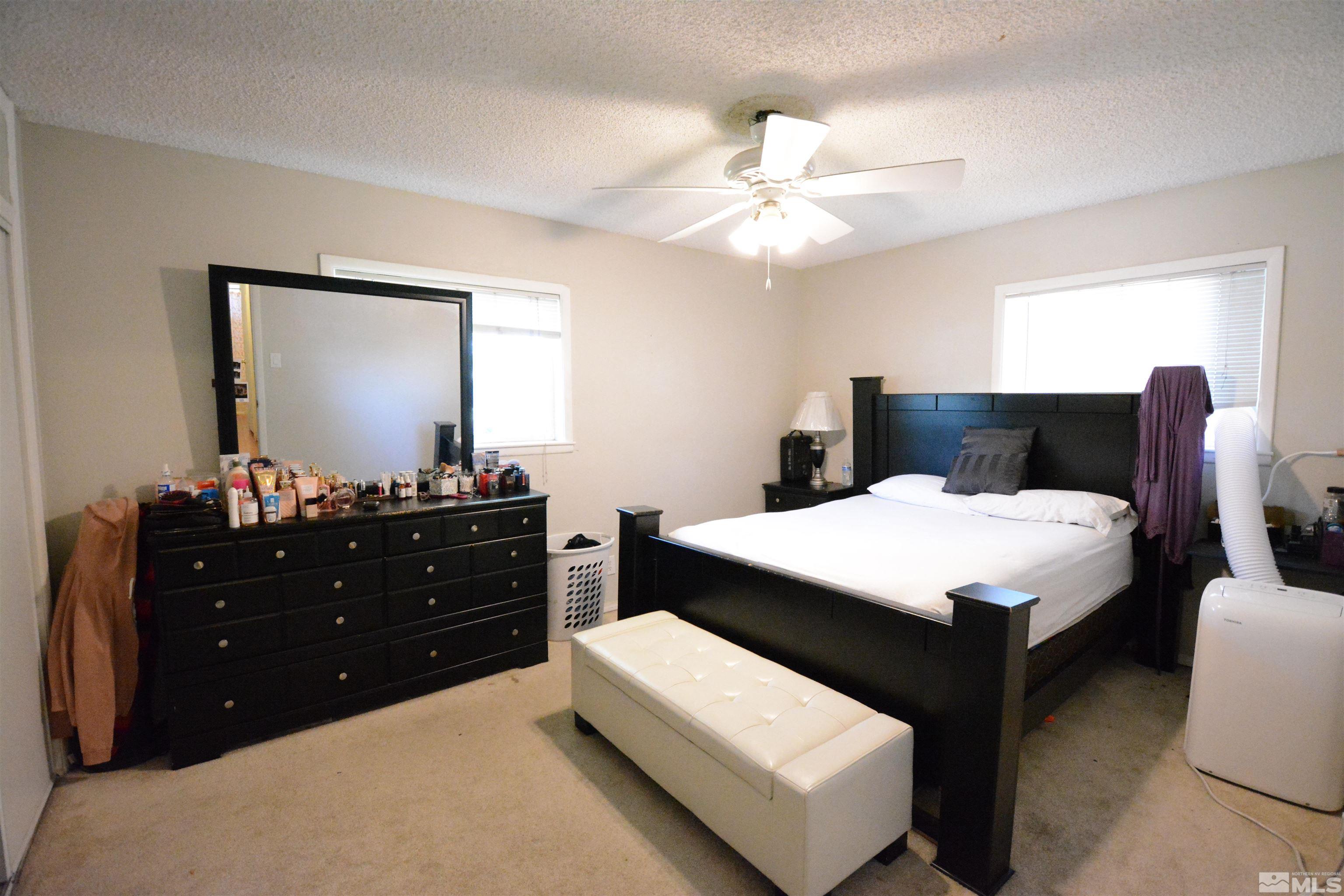 1930 Trainer Way Reno, NV 89512 - Photo 7 of 24 a bedroom with a bed and a mirror on dresser