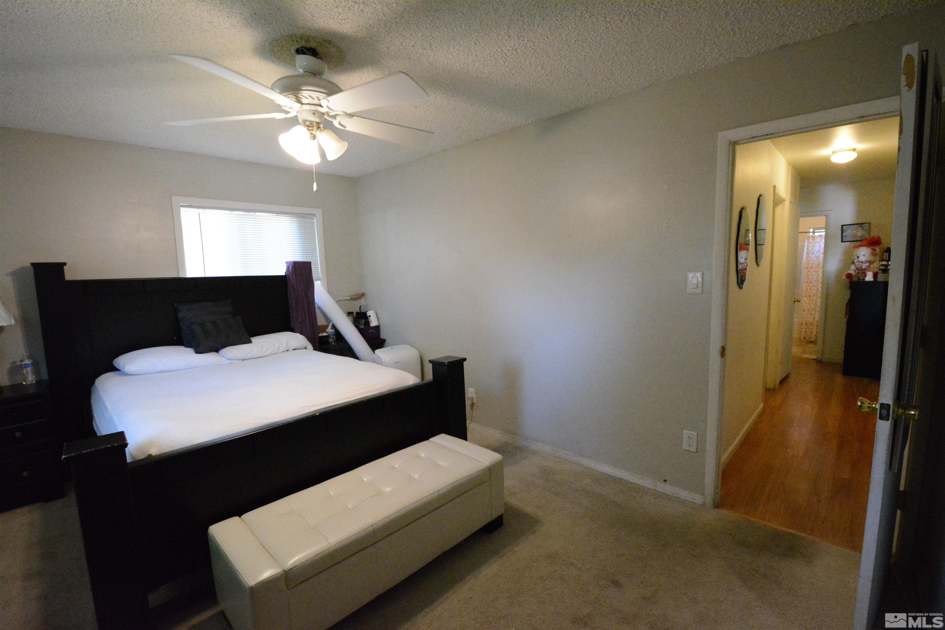 1930 Trainer Way Reno, NV 89512 - Photo 8 of 24 a bedroom with a bed and a chandelier