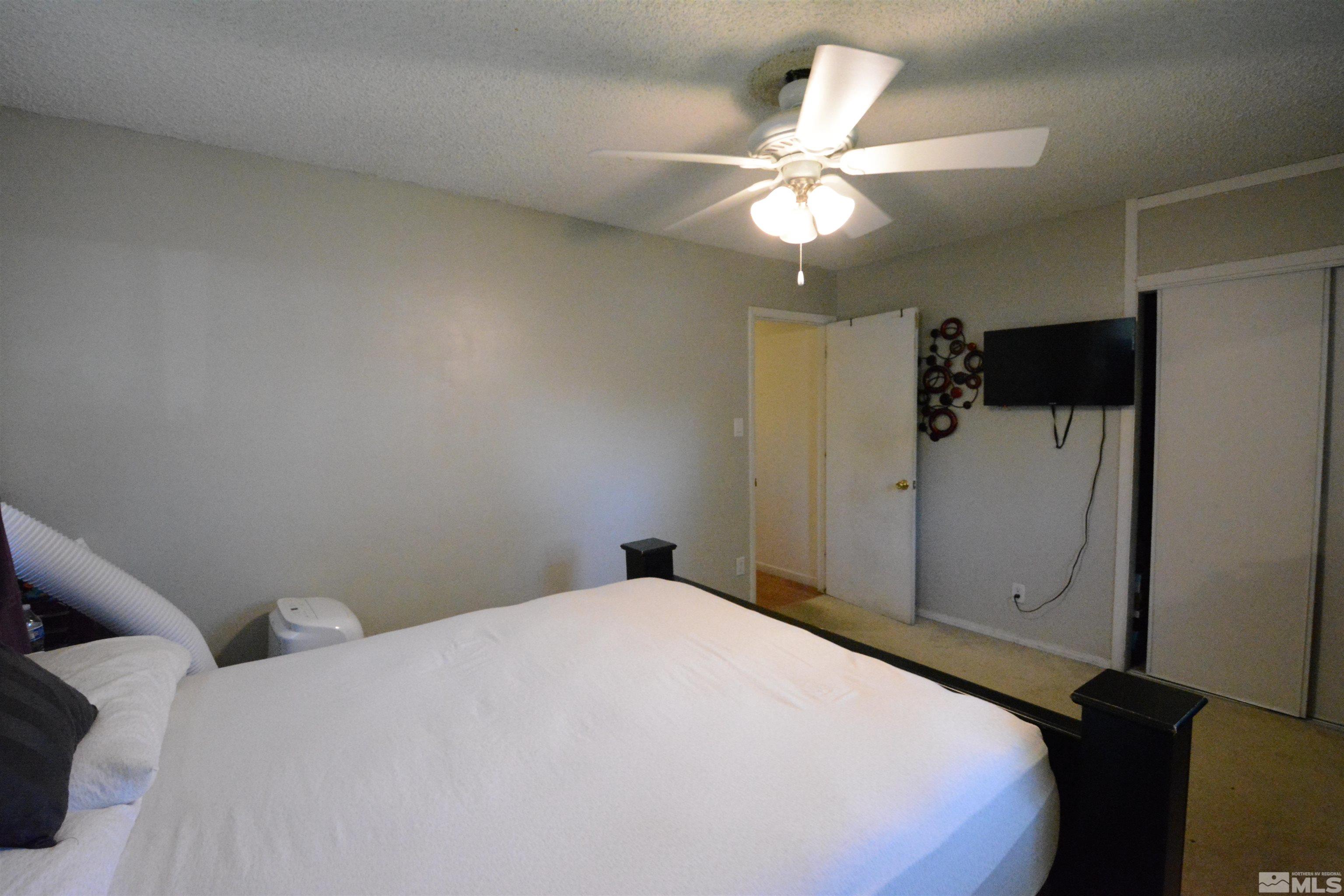 1930 Trainer Way Reno, NV 89512 - Photo 9 of 24 a bedroom with a bed and a ceiling fan