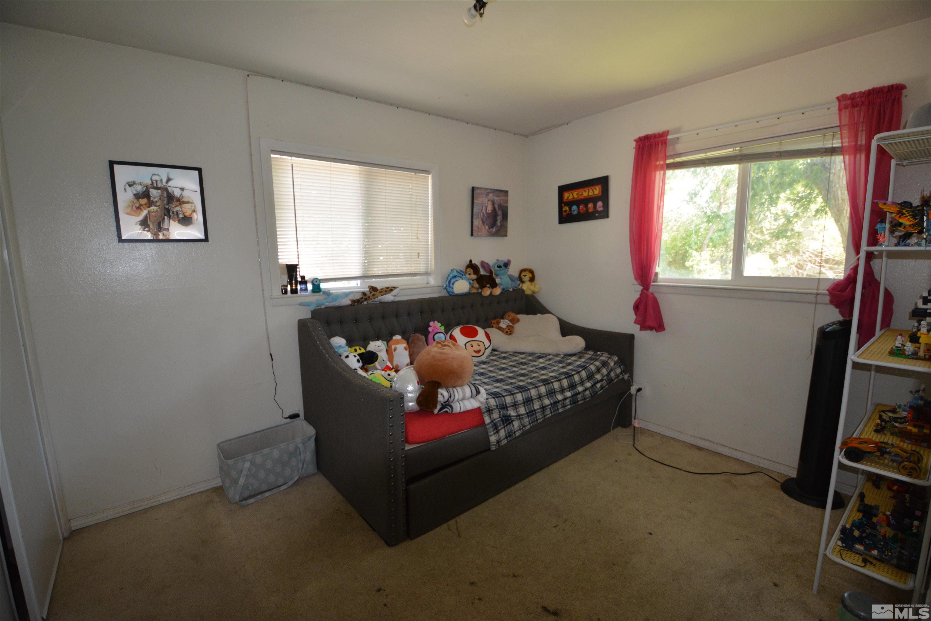 1930 Trainer Way Reno, NV 89512 - Photo 10 of 24 a bed sitting in a bedroom next to a window