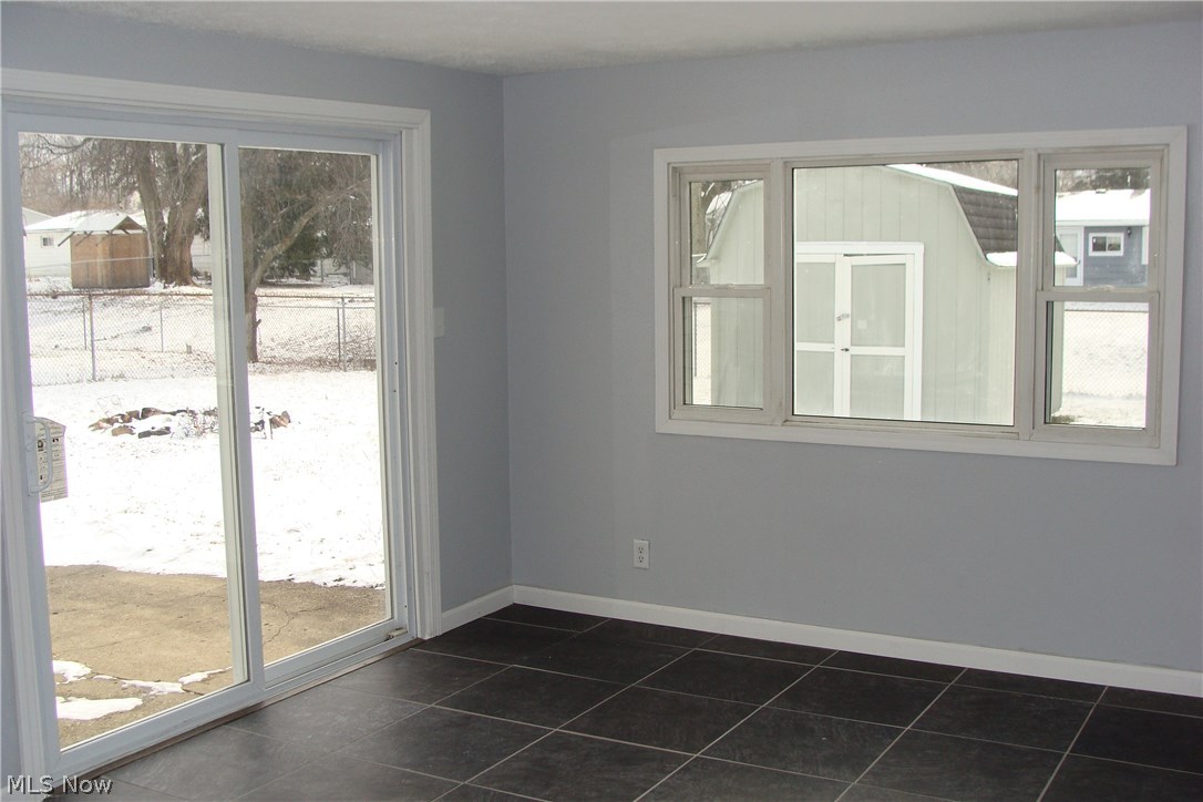 3008 Polly Road Ravenna, OH 44266 - Photo 20 of 27 Family room looking outside trough window and sliders to back patio