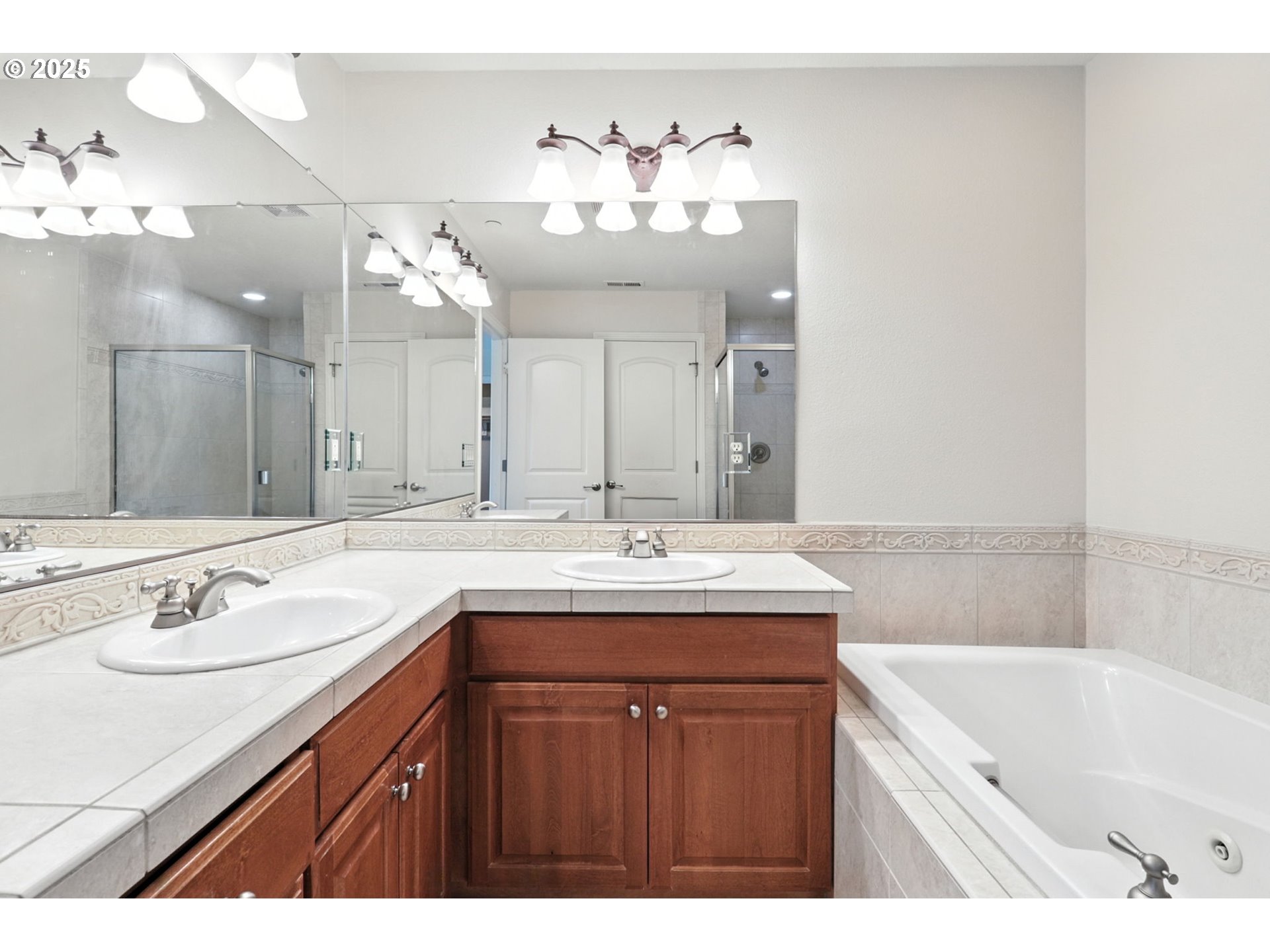 2052 Northwest Fargo Loop Camas, WA 98607 - Photo 18 of 44 a bathroom with a granite countertop sink a large mirror and a bathtub
