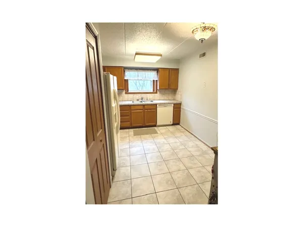a kitchen with a stove a sink and a refrigerator