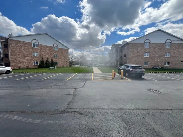 a view of a brick building next to a yard