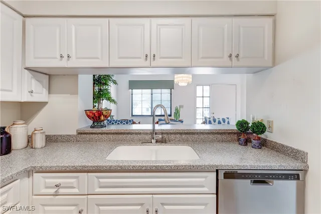 a kitchen with white cabinets and a sink