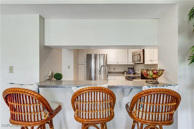 a kitchen with a kitchen island a stove a table and chair