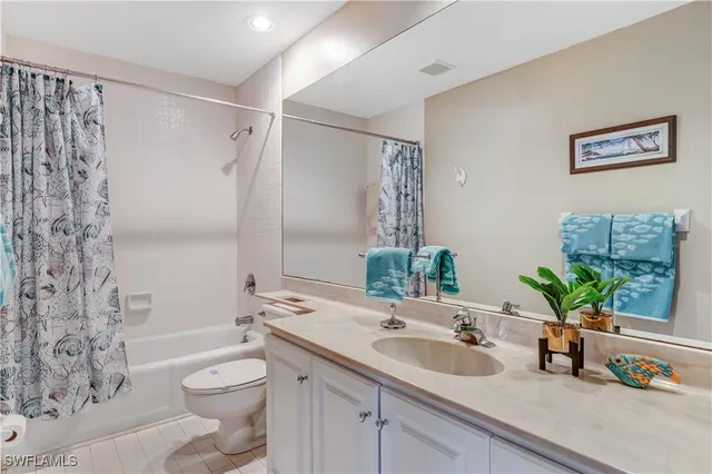 a bathroom with a sink a toilet and a large mirror