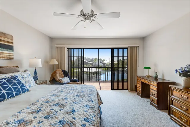 a bedroom with furniture and large windows