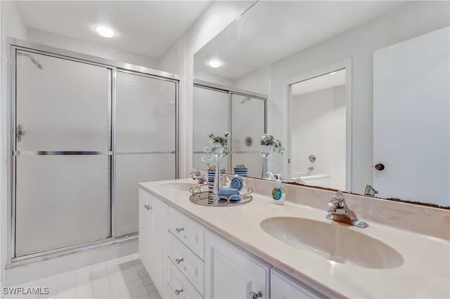 a bathroom with a double vanity sink and a mirror