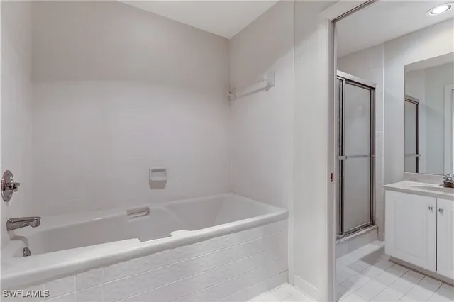 a white bath tub sitting next to a white sink