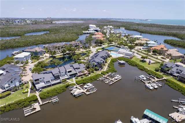 an aerial view of a house with a garden and lake view