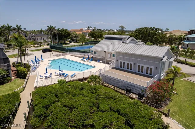a view of swimming pool with a lounge chairs