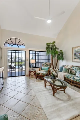 a living room with furniture and a floor to ceiling window