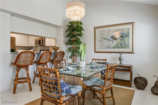a view of a dining room with furniture and chandelier